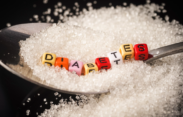 Diabetes Concept: Diabetes wordings on top of sugar heaps. November is World Diabetes Month